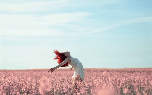 Young woman looking happy and relieved, representing successful tinnitus management and improved quality of life.