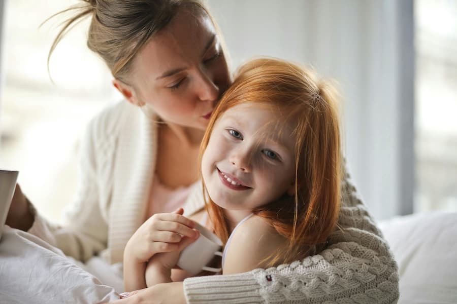 Mother and daughter sharing a moment, illustrating the question of whether tinnitus can be hereditary and run in families.